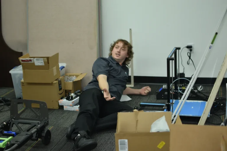 He's probably saying "Why are there no tables or chairs?!"